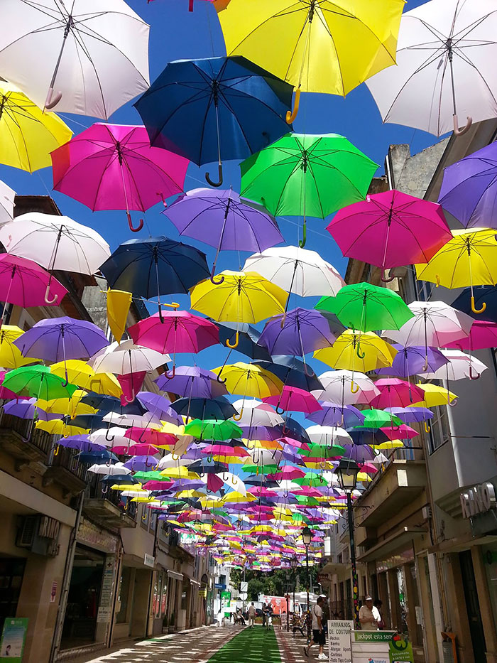Colourful umbrellas shading street in Portugal [381] filt3rs